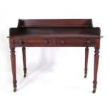 A Victorian mahogany wash stand with shelved 3/4 gallery above two faux drawers, tapering