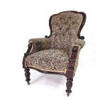 A Victorian mahogany framed gentleman's chair with buttoned back, serpentine seat, baluster front