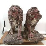 A pair of cast reconstituted stone figures of lions, seated facing to left and right. 58 x 75 cm