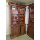 A Victorian mahogany bookcase on cupboards, pair of arching glazed doors enclosing adjustable