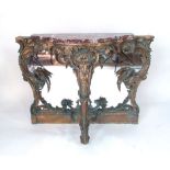 A Rococo style gilt wood and gesso pier table of serpentine form, the white and grey veined red