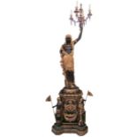 A pair of gilt bronzed Blackamoor candelabra, cast as nubians holding up a four light candelabra