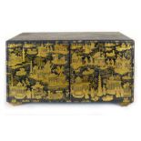 A Chinese black lacquered and tooled gilt decorated table cabinet, pair of doors enclosing a