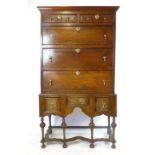 An oak chest on stand, late 17th Century and later, two short and three graduated long drawers on