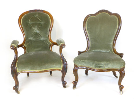 A matched pair of Victorian walnut framed chairs with spoon shaped backs, serpentine seats and