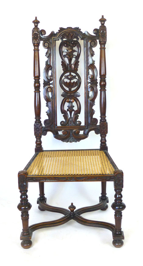 A Carolean style oak chair with scrolling, foliate, pierced back above a cane seat, turned legs - Image 2 of 3