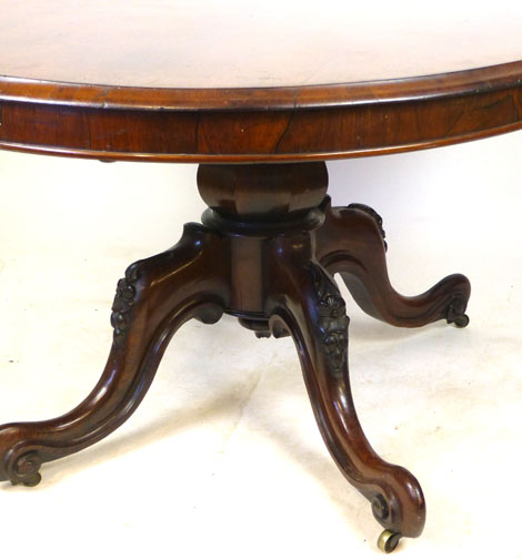 A Victorian rosewood oval tilt top breakfast table, raised on a foliate carved quadripartite - Image 4 of 4