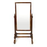 A Victorian mahogany cheval mirror, rectangular plate on column supports, the base with down swept