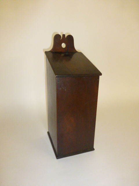 A walnut candle box, possibly late 18th Century of square section with pierced wall bracket. h. 43