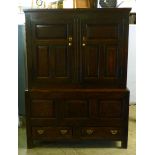 An oak livery cupboard, 18th century and later, a pair of panelled doors above a panelled base