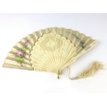 A 19th Century bone and silk fan with pierced and painted floral decoration. w. 40 cm. CONDITION