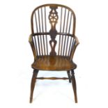 An ash and elm medium back Windsor chair, with wheel splat, solid seat and 'H' stretcher.