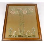 An embroidered panel worked in coloured silk threads with a stylized rose and other flowers on a