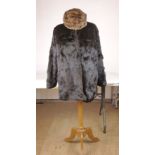 A brown fur jacket together with a fur hat (2)