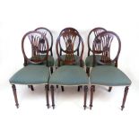 A set of six Sheraton style mahogany dining chairs, with oval backs, pierced splats and stuffed over
