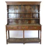 An oak dresser, 18th Century and later, two shelf plate rack with wrought iron spoon hooks on a base