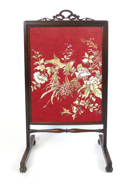 A rosewood framed fire screen, foliate pierced handle, of rectangular screen and square section