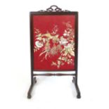 A rosewood framed fire screen, foliate pierced handle, of rectangular screen and square section