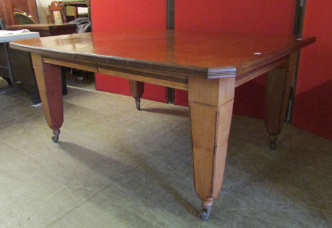 A late Victorian mahogany extending dining table, canted rectangular form on tapering square section