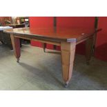 A late Victorian mahogany extending dining table, canted rectangular form on tapering square section