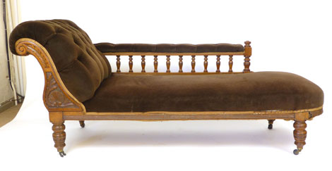 A Victorian oak framed chaise longue with button scroll arm and spindle supports. l. 190cm CONDITION