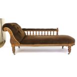 A Victorian oak framed chaise longue with button scroll arm and spindle supports. l. 190cm CONDITION