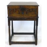 An oak bible box and stand, 17th Century and later, hinged cover enclosing a vacant interior,