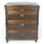 A German mahogany chest of four graduated long drawers with brass escutcheon and carved uprights,