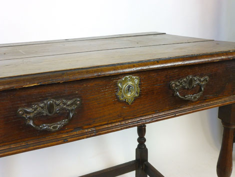 An oak low boy, 18th Century and later, rectangular panel top above a frieze drawer, baluster turned - Image 2 of 2