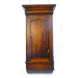 An oak cabinet, probably originally the base to a wall clock, with arching door and curved base.  h.