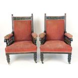 A pair of Victorian oak framed easy chairs, padded back and arm rests, stuffed over seats (2)