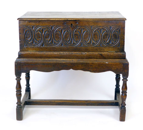 An oak bible box on stand, late 17th century and later, two plank top above a carved and  hinged