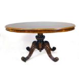 A Victorian walnut oval tilt top breakfast table raised on a quadripartite base, l. 142 cm