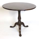 A George III mahogany circular tilt top occasional table on a baluster and column tripod base,d.