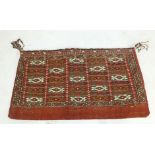 A pair of Turkman Kilim weave bags with bands of geometric design on a madder ground,