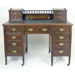 An Edwardian walnut and leather inlaid twin pedestal desk, the superstructure with four trinket