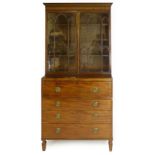 An early 19th century mahogany secretaire bookcase, the pair of arching astragal glazed doors on a