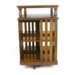 An Edwardian oak revolving bookcase with raised upper shelf and numbered bookshelves, h. 115 cm,