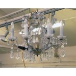 A Venetian style glass six branch chandelier with cut glass droplets and flower heads,  d.