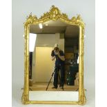 A Florentine style gilt framed wall mirror with scrolling floral and foliate decoration, h. 155