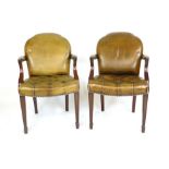 A pair of leather upholstered elbow chairs with button seats (2) CONDITION REPORT: Leather worn in