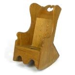 A child's oak rocking wing backed chair with heart shaped cut out back and commode seat  CONDITION