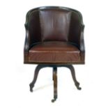 An Edwardian mahogany and leatherette upholstered swivelling office chair, with a four star base and