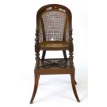 A Victorian mahogany and caned child's high chair and stand, h.