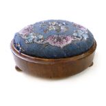A Victorian walnut circular footstool with blue ground bead work upholstery on turned squat feet, d.