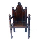 A late 19th century Gothic Revival oak armchair,