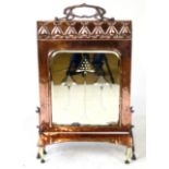 An Art Nouveau copper and mirrored fire screen with separate ledge,