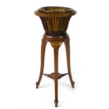 An Edwardian mahogany and satinwood inlaid jardiniere stand with a brass liner, h.