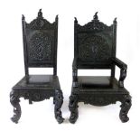 A his and hers pair of Burmese carved and ebonised teak chairs,