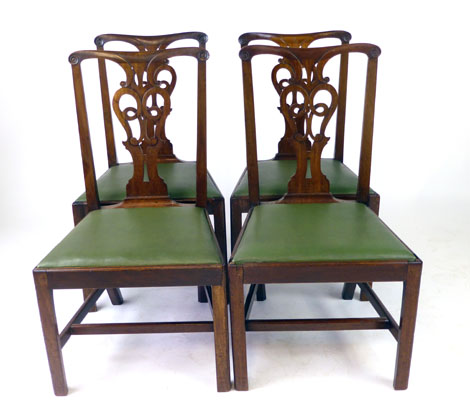 A set of four late 18th century mahogany and green faux leather dining chairs,